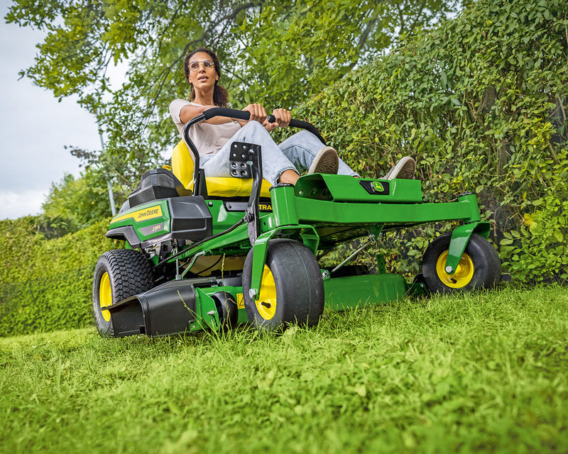Zero Turn Mower cutting alongside hedge