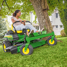 John Deere zero turn cutting around a tree