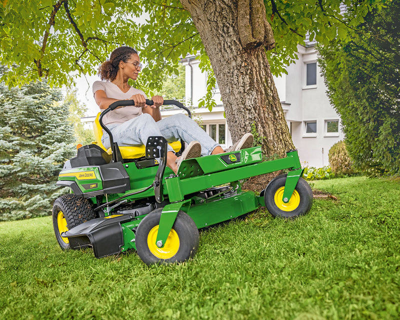 John Deere zero turn cutting around a tree