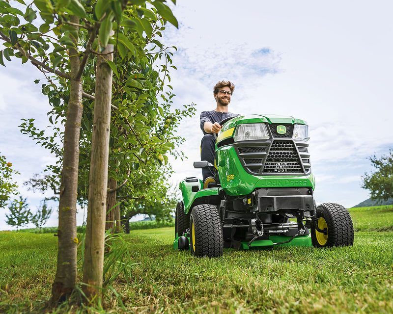 Mowing tractor in an orchard